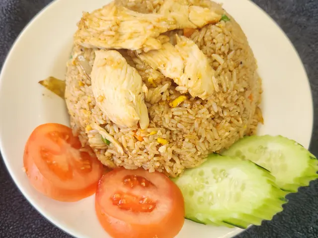 Pineapple fried rice with egg, peas and cashews.