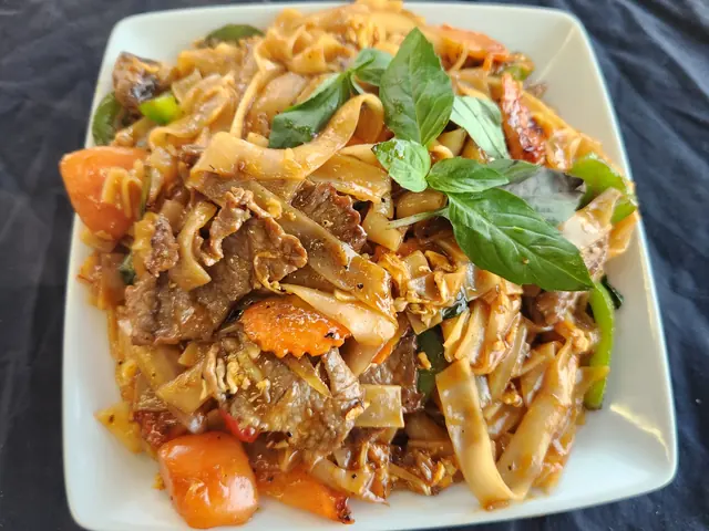 Pad ke mow — wide rice noodles stir-fried with basil and chilli.