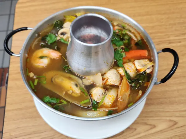 Tom yum combination seafood soup in a hot pot.